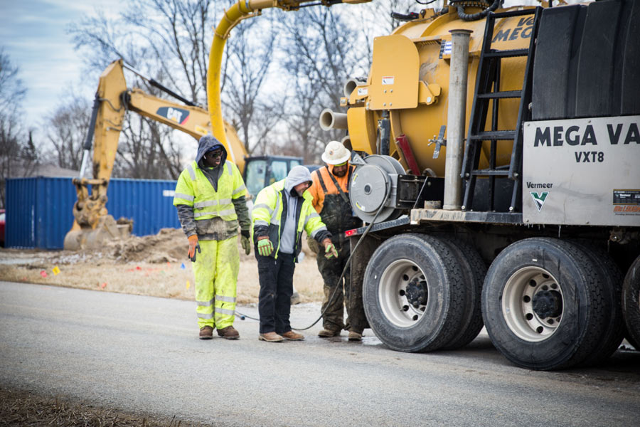workers behind truck